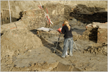 Woman standing in an archeology dig site