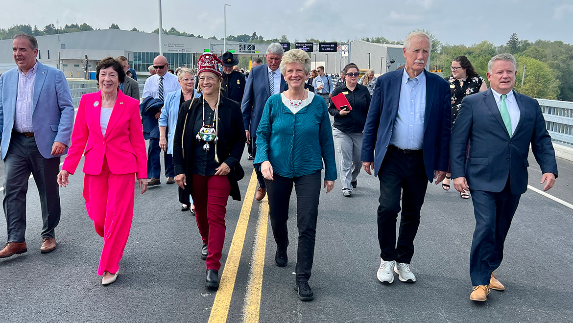 Madawaska Land Port of Entry ribbon cutting Group of people walking over a bridge.